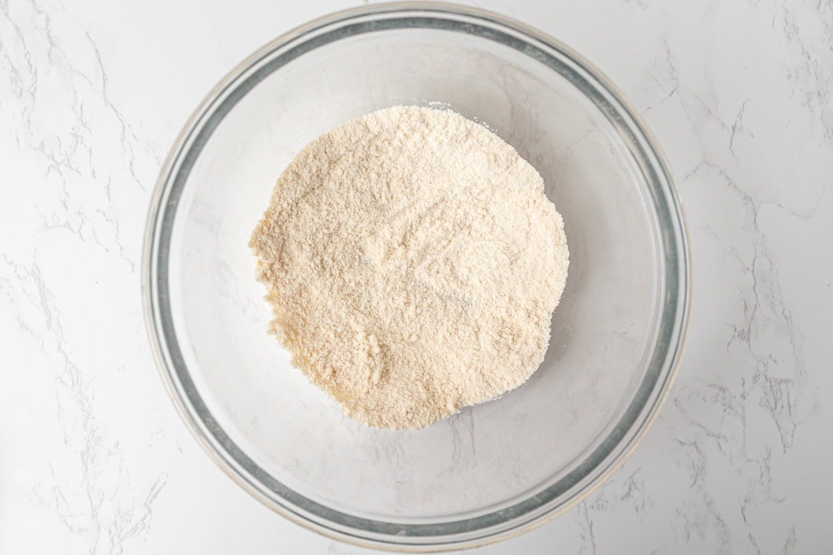 Coconut flour in a glass mixing bowl ready to be combined for gluten-free waffle batter