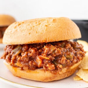 Gluten-free sloppy joe sandwich on a toasted bun filled with saucy ground beef mixture