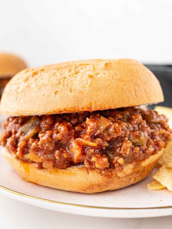 Gluten-free sloppy joe sandwich on a toasted bun filled with saucy ground beef mixture