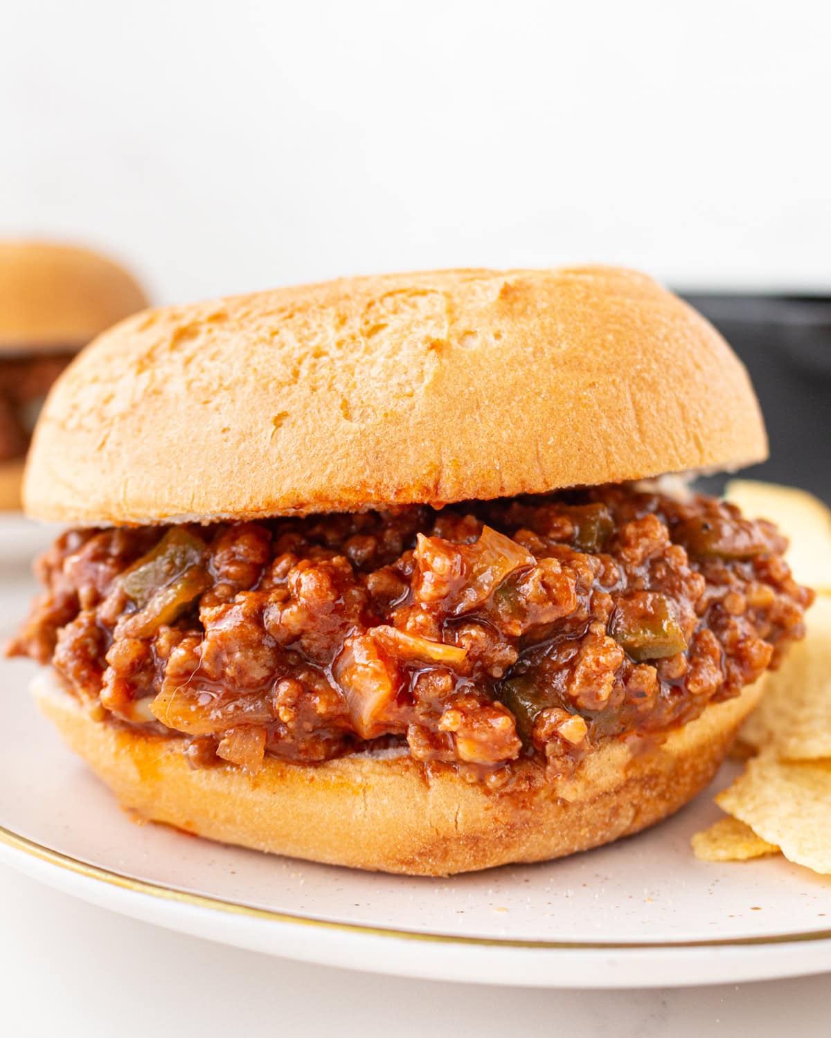 Gluten-free sloppy joe sandwich on a toasted bun filled with saucy ground beef mixture
