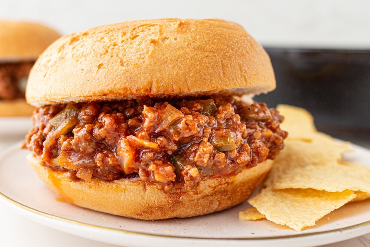 Close-up of gluten-free sloppy joe sandwich served with potato chips
