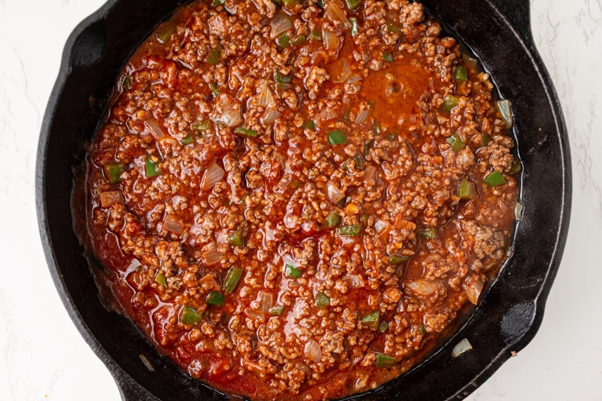 Sloppy joe meat mixture with tomato sauce added in a skillet