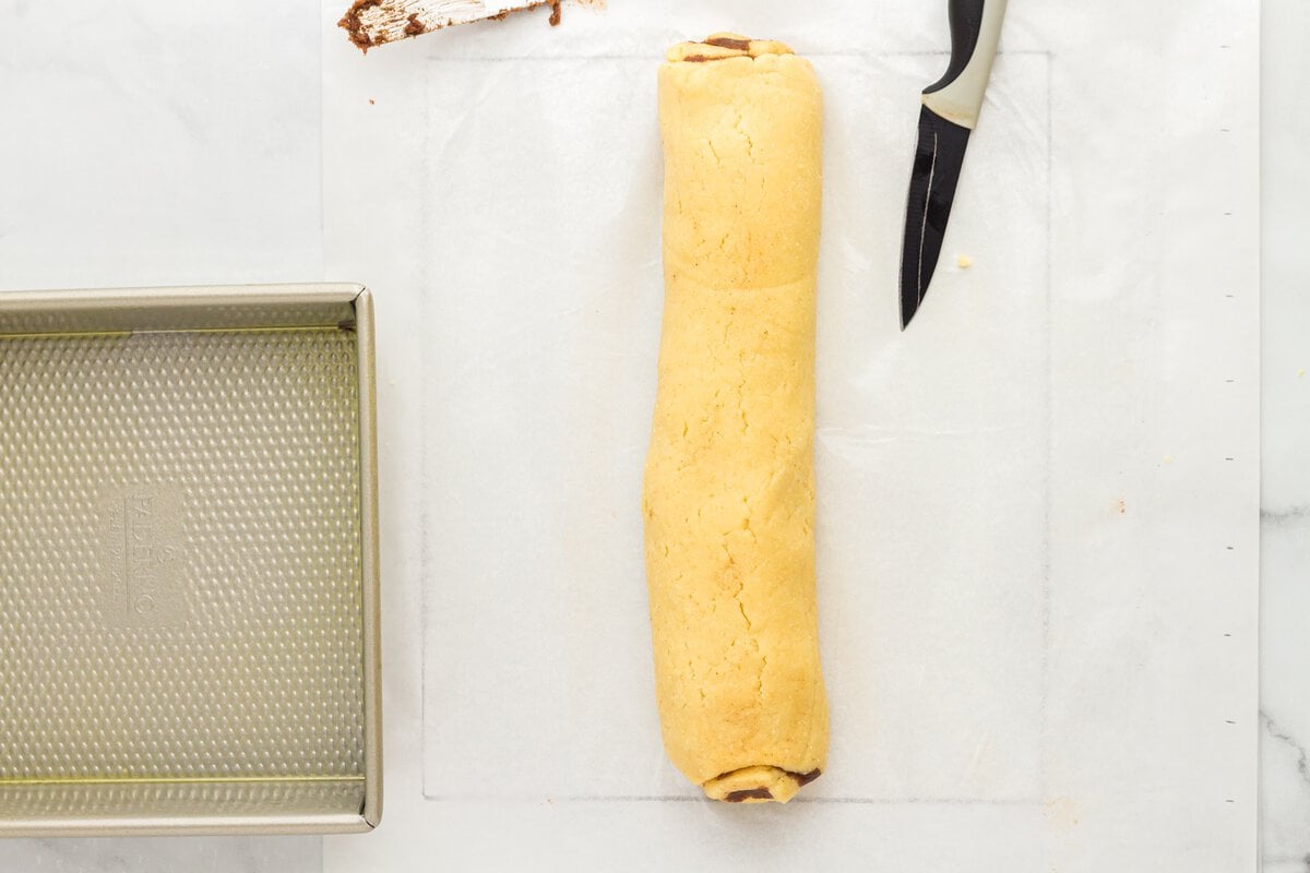 Rolled cinnamon dough log before slicing into rolls