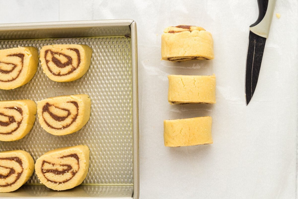 Sliced keto cinnamon rolls arranged on a baking pan before baking