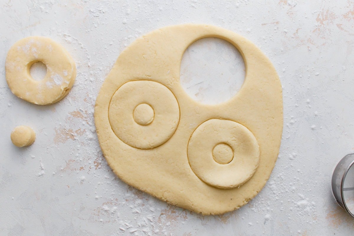 Gluten-free mochi donut dough cut into donut shapes before frying