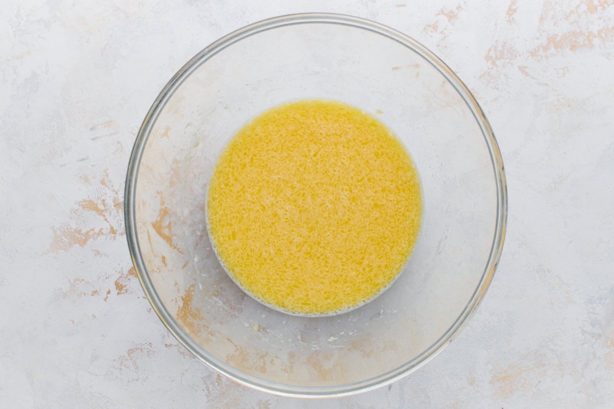 Wet ingredients for gluten-free mochi donuts mixed together in a glass bowl