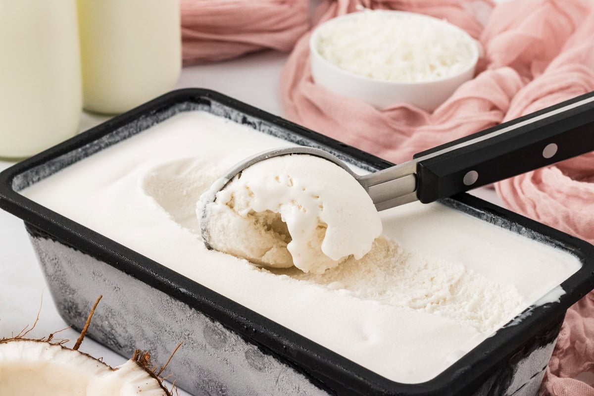 Scoop of creamy coconut sorbet served straight from the freezer container.