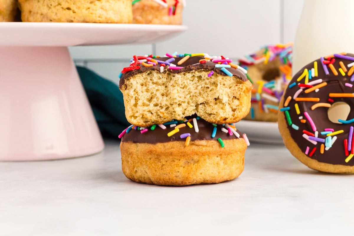 Gluten-free vanilla cake donut cut in half to show the soft fluffy interior and tender crumb.