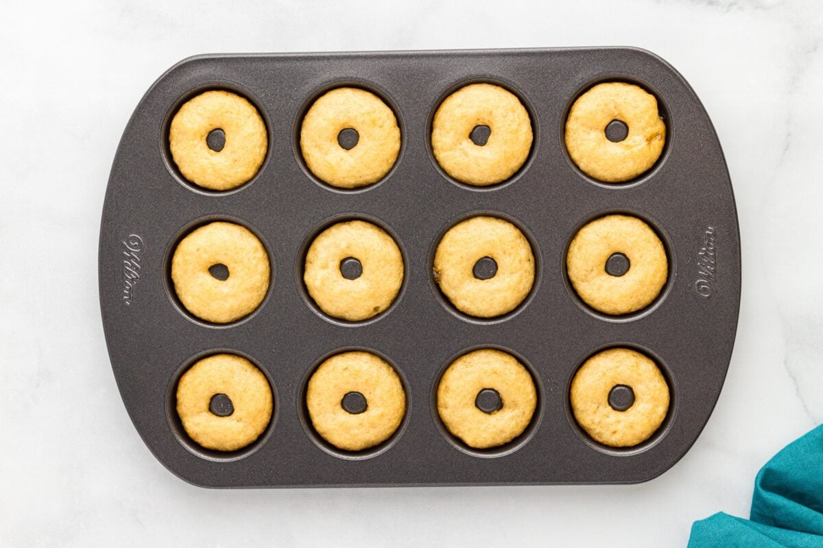 Mini gluten-free vanilla cake donuts baked in a mini donut pan with lightly golden tops.
