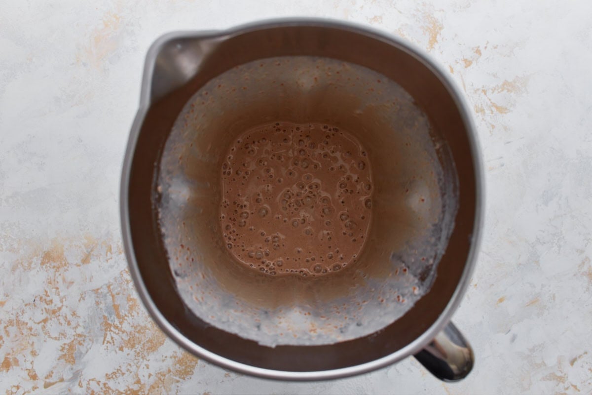 Blended date ice cream base in a blender pitcher, smooth and creamy with a light caramel color.