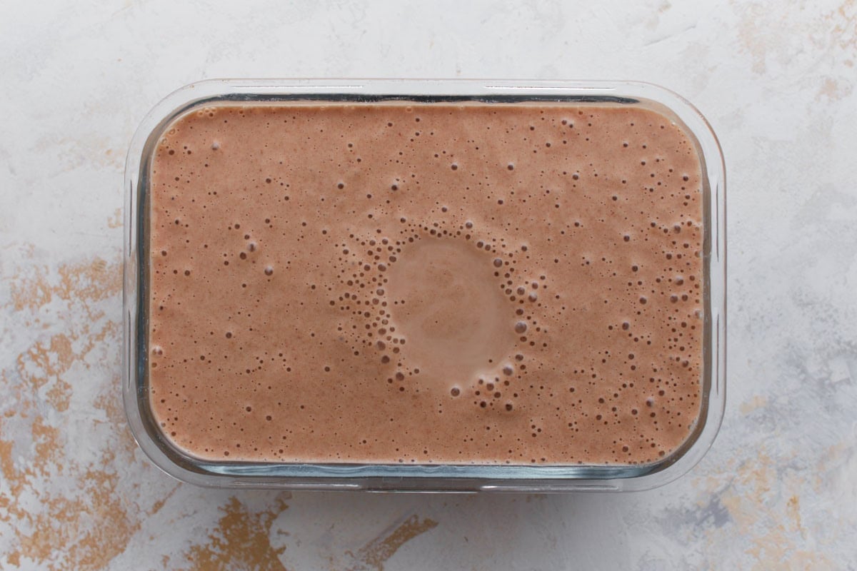 Homemade date ice cream mixture poured into a freezer-safe container before freezing.