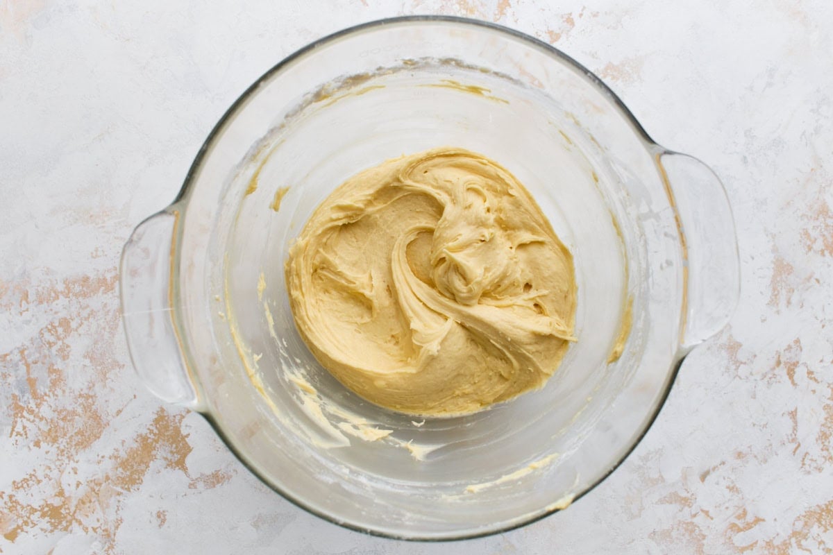 Smooth gluten-free sponge cake batter in a glass mixing bowl