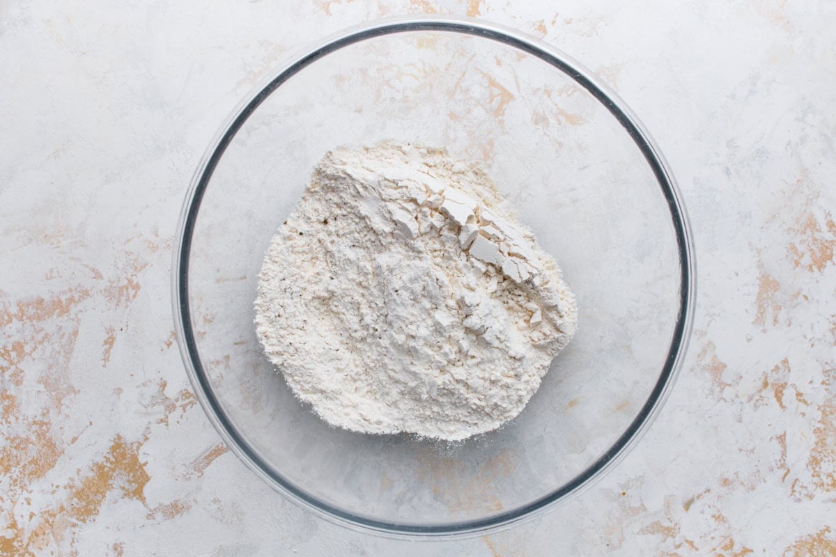 Gluten-free flour blend in a glass mixing bowl before the wet ingredients are added.